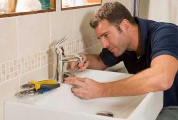 plumber in Allen TX installs sink faucet